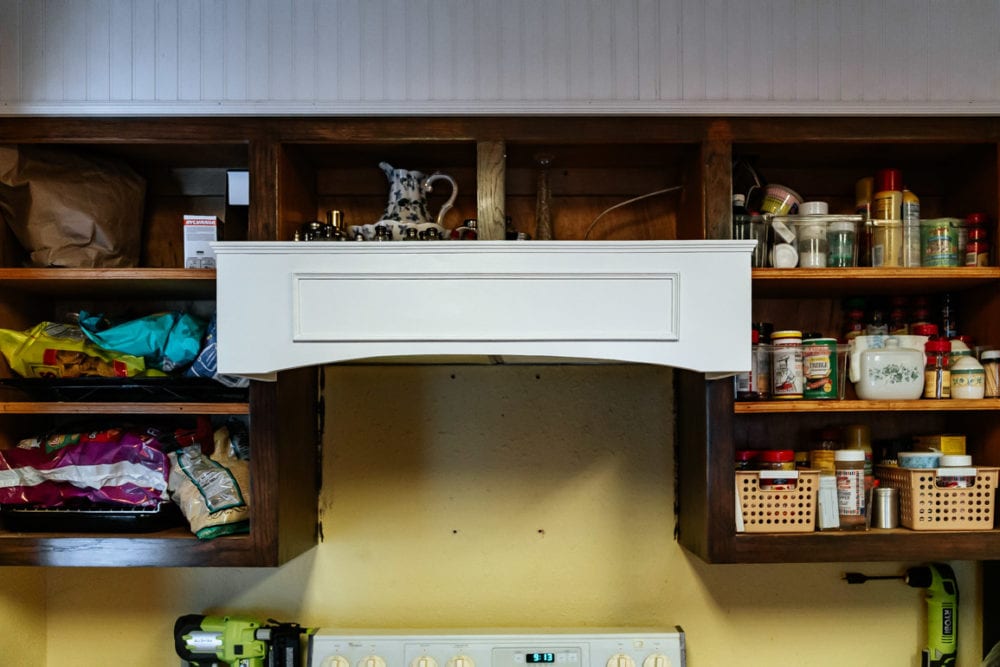 white vent hood cover in an in-progress kitchen