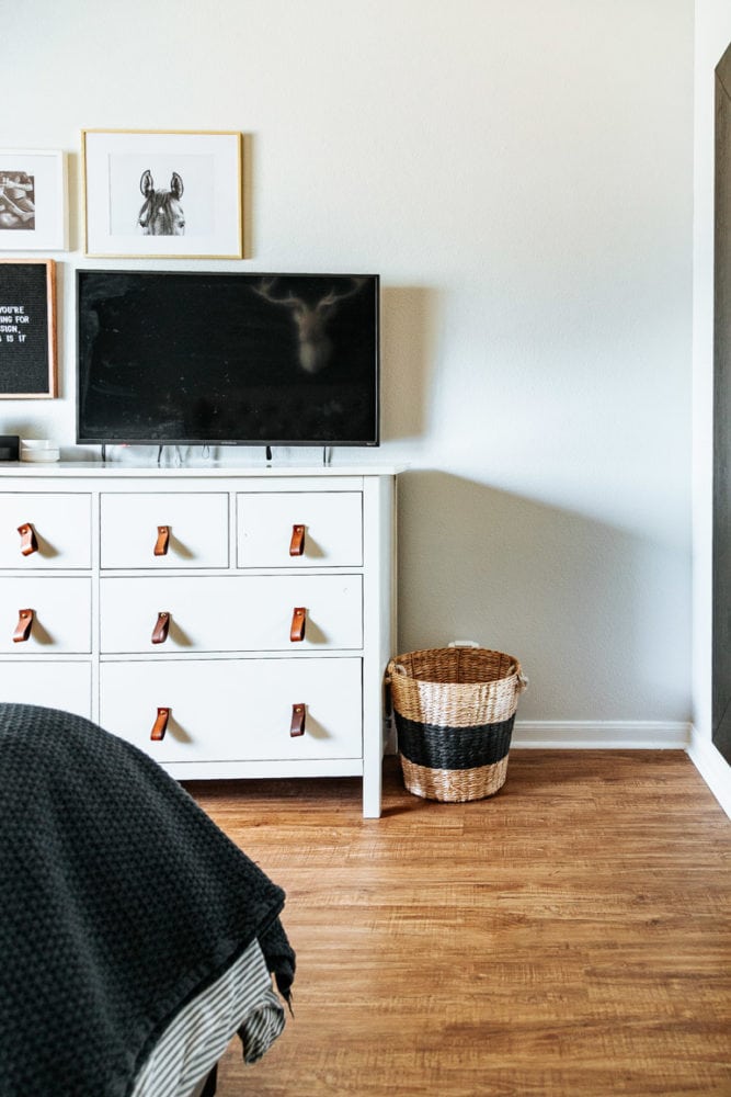 a corner of a master bedroom with white walls