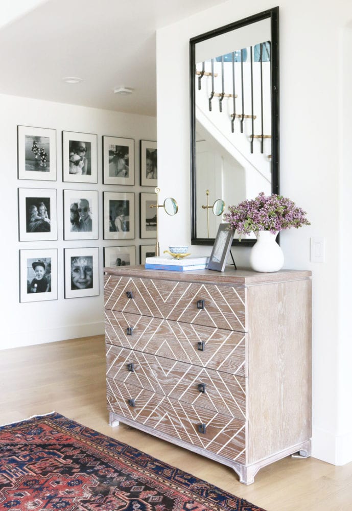 hallway with grid of family photos