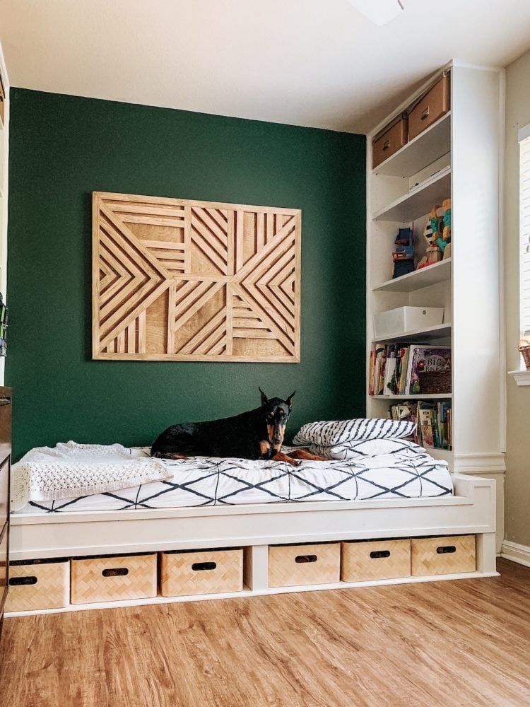 A kids' bedroom with a built-in bed and a green wall