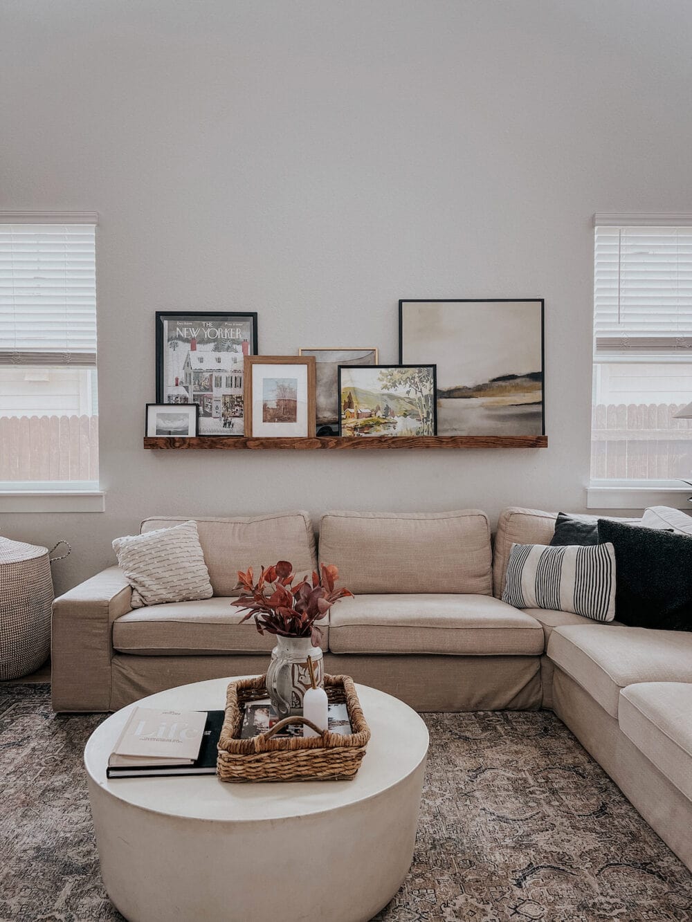 a simple family photo wall idea - using a picture ledge to display favorite family images 