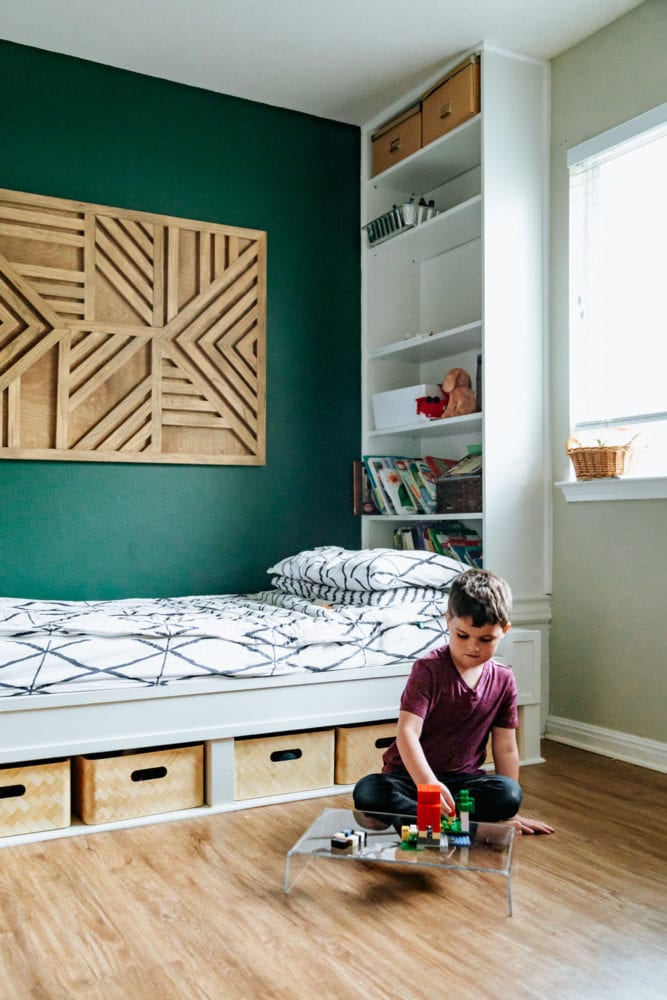 young boy playing on an acrylic lap desk in his bedroom