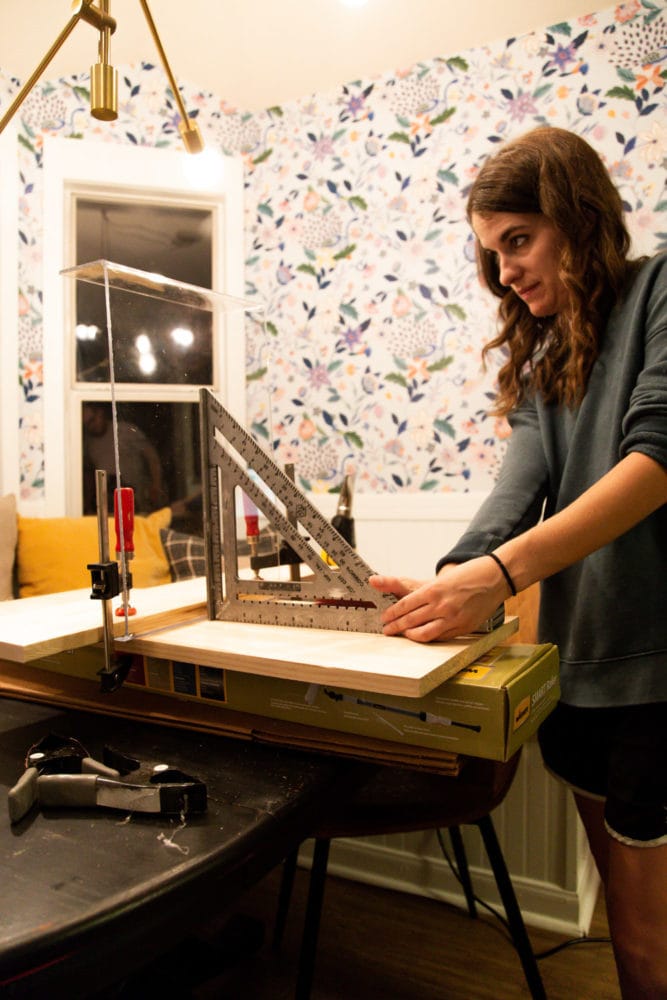 woman bending plexiglass to make DIY lap tray