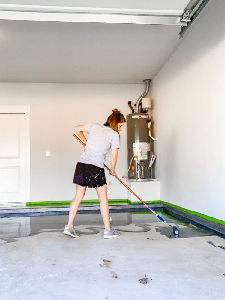 woman painting garage floor 
