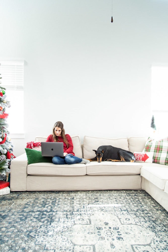a woman and dog on an IKEA KIVIK sectional sofa