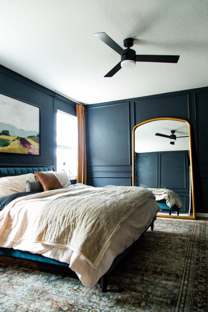 bedroom with picture trim and a large mirror