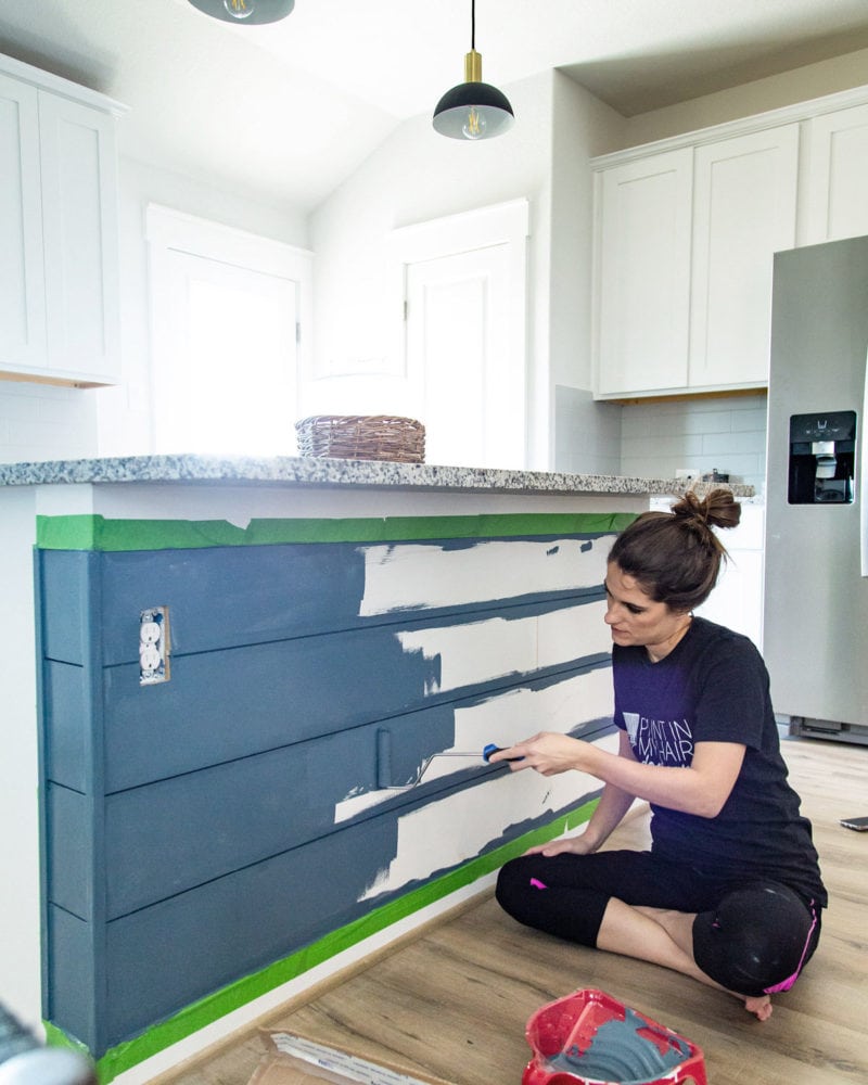 woman painting a kitchen island