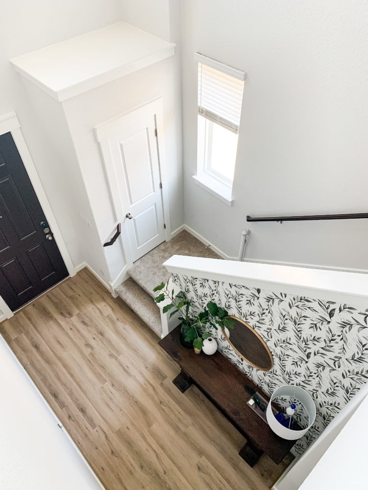 Entryway with black and white floral wallpaper