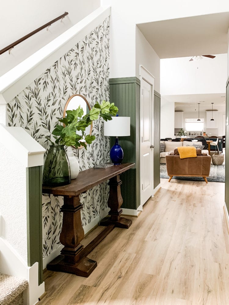 entry with floral wallpaper and green paneling