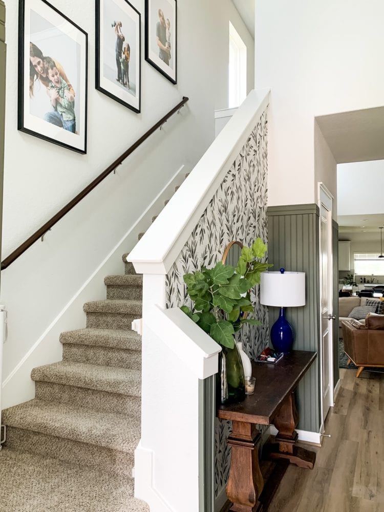 staircase with wallpaper and large prints