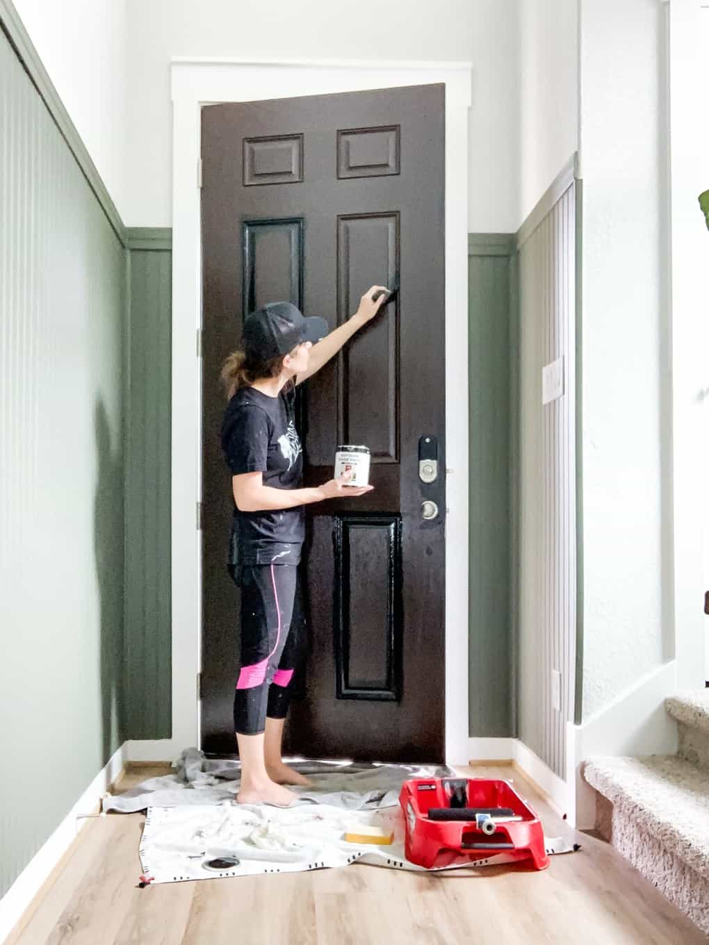 Woman painting a front door 