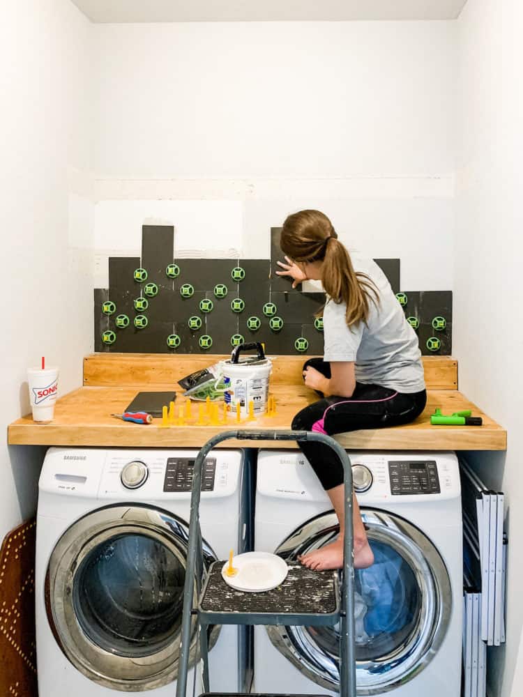 Woman installing basalt tile