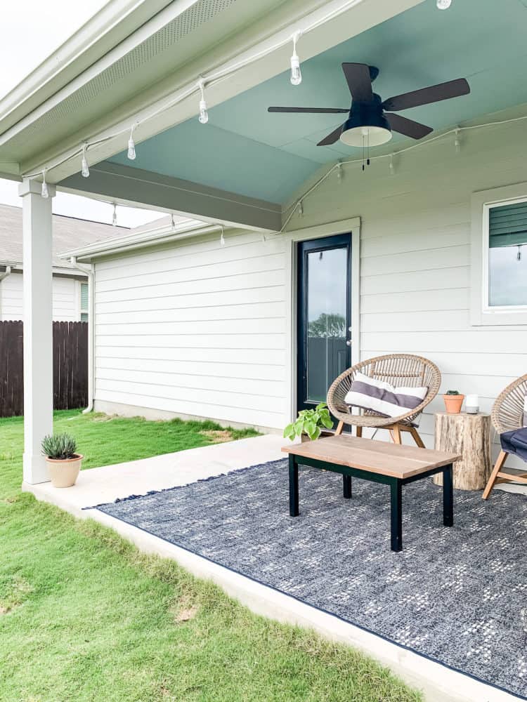 a back porch with a blue painted ceiling 