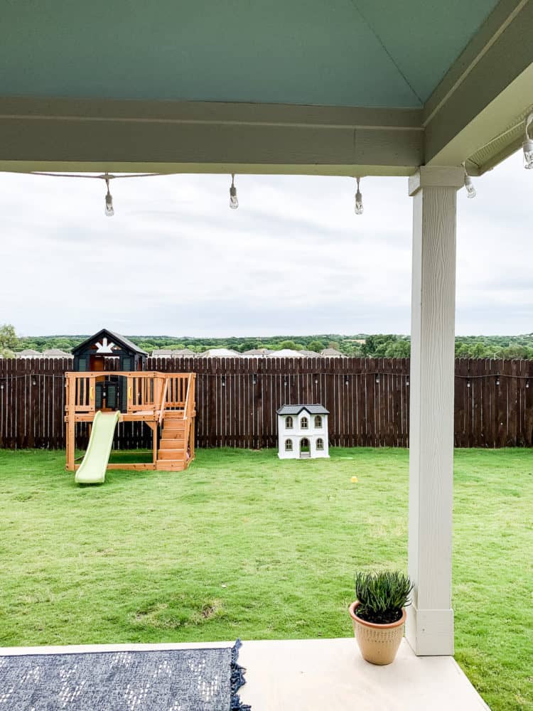 ansmall backyard with kids toys and a haint blue porch ceiling