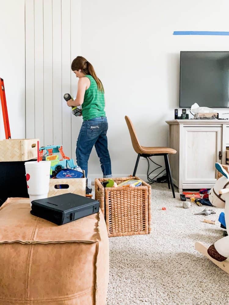 Woman installing vertical shiplap