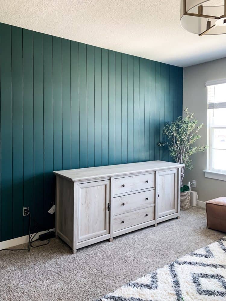 Wall with green vertical shiplap paneling