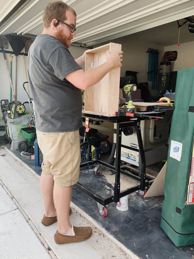 man assembling a drawer for a kitchen cabinet 