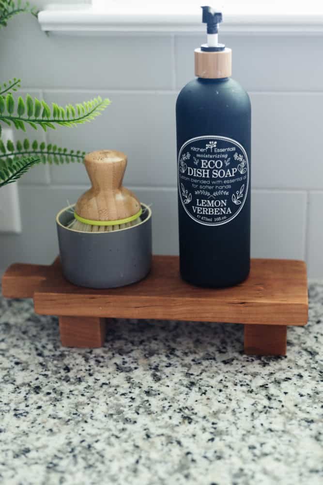 footed pedestal tray by kitchen sink