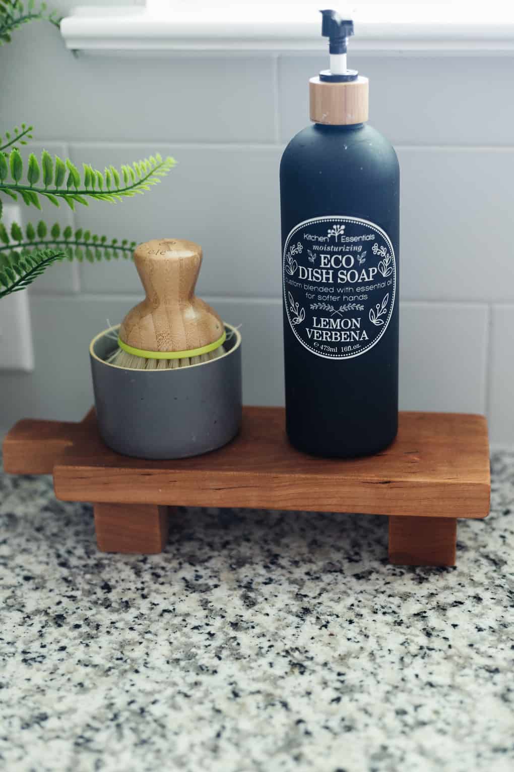 footed pedestal tray by kitchen sink