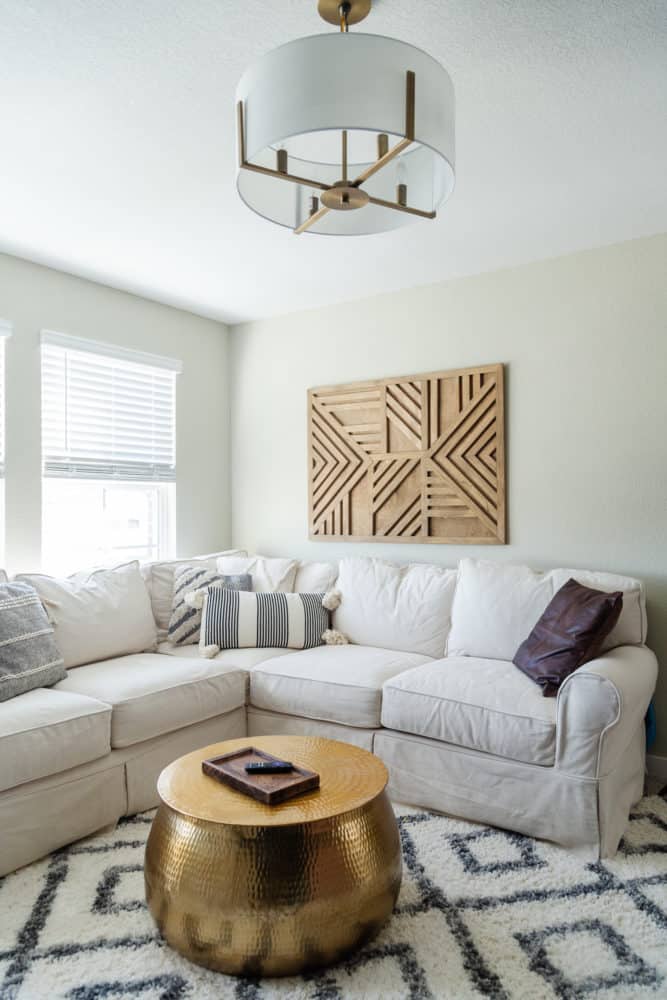 corner of a cozy family room with a sectional and a plush rug