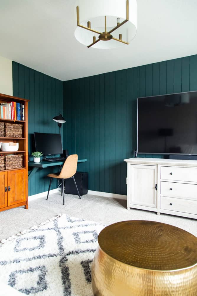 corner of bonus room with vertical shiplap