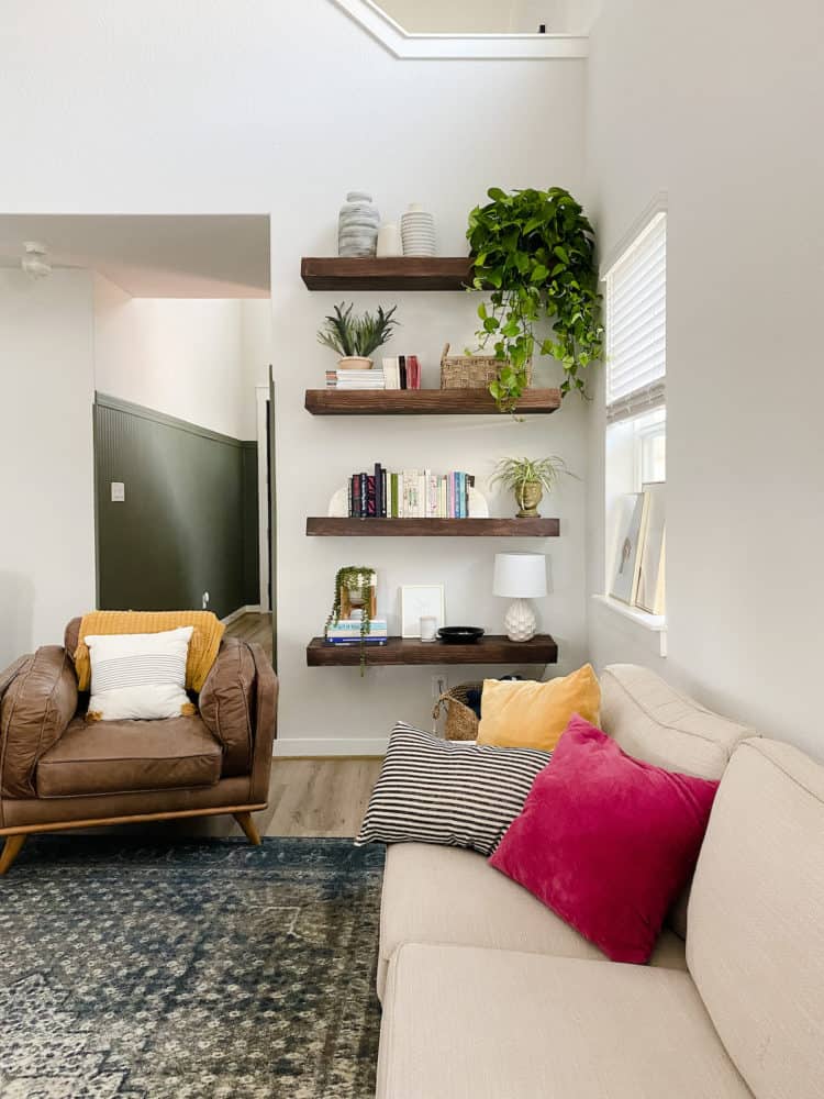 living room with floating wood shelves in a corner 