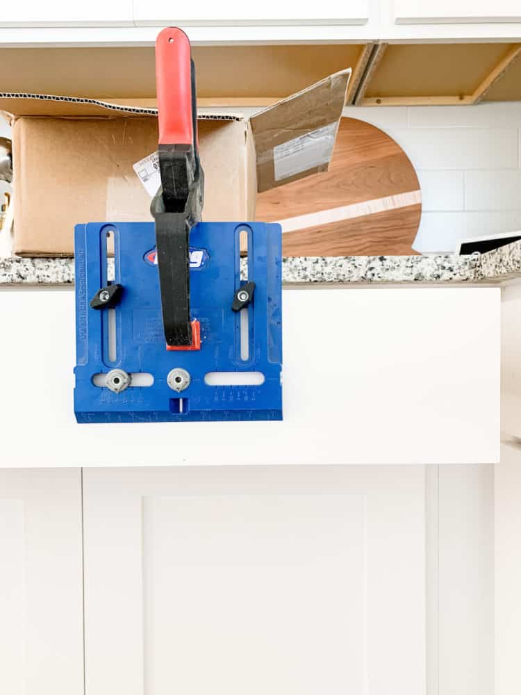 Kreg Cabinet Hardware Jig clamped to a drawer front