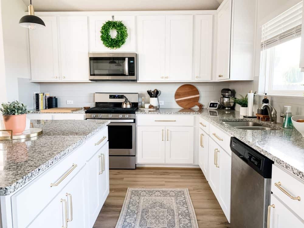 Kitchen with white. cabinets and gold hardware 