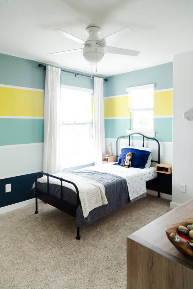 kid bedroom with bold and colorful stripes on the wall