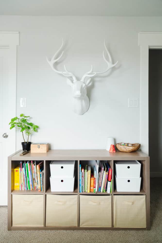 kid room with bookcase and faux deer head on the wall