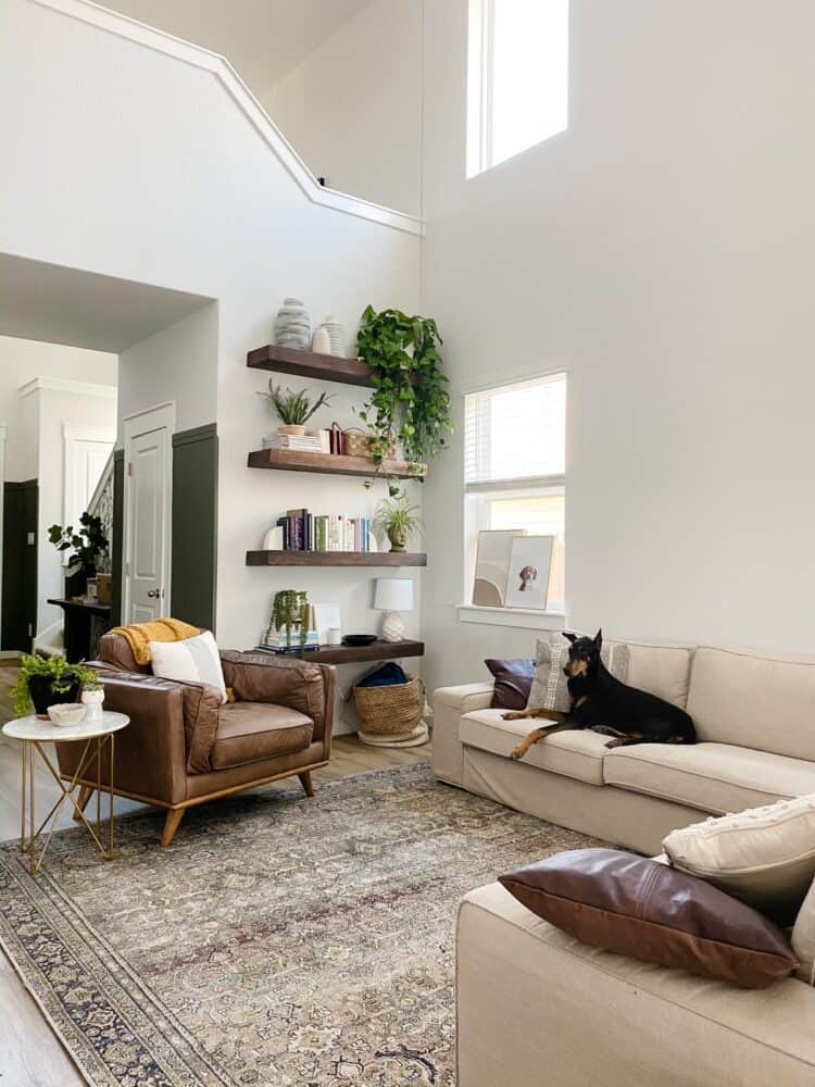 open concept living room with floating shelving