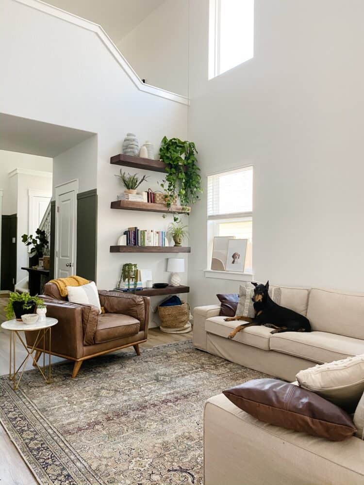 open concept living room with floating shelving 