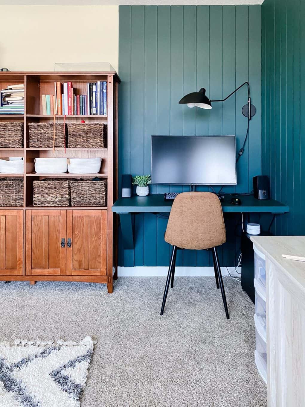 a floating desk set up in a corner of a bonus family room