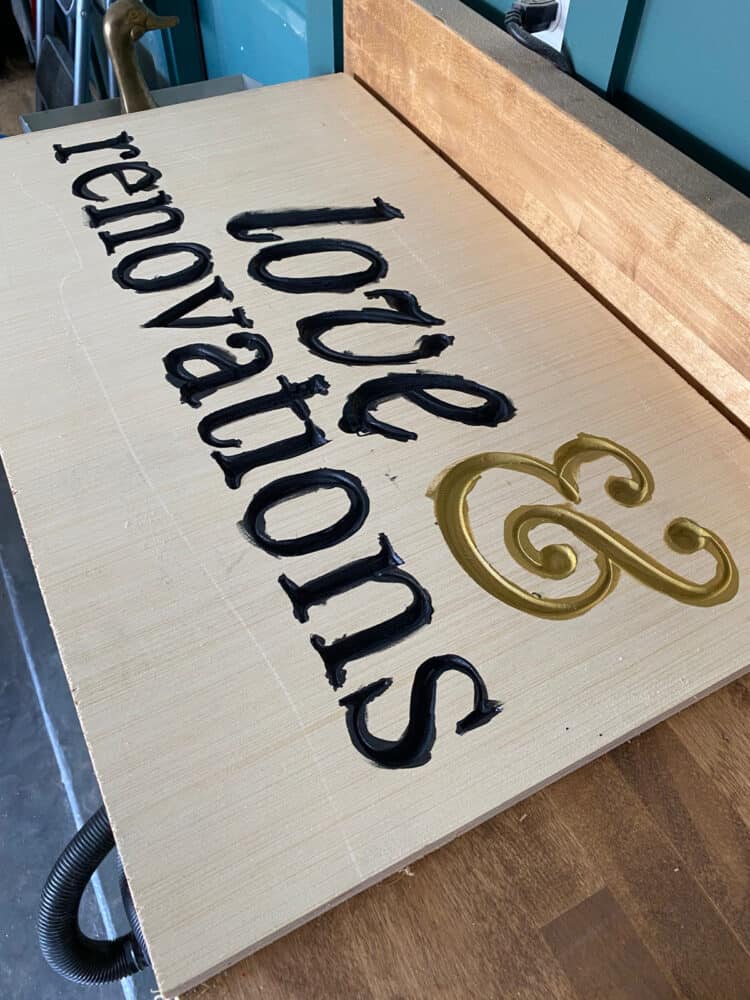 carved wood sign with letters painted 