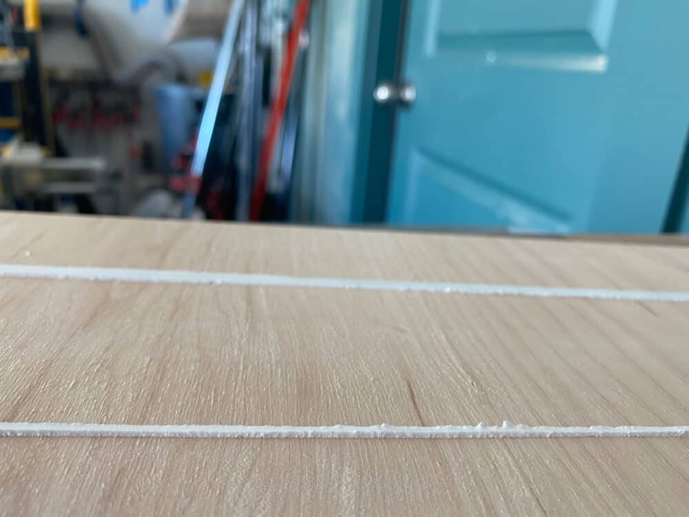 close up of a bead of caulk where tape was applied very close to the line