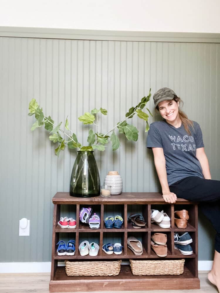 woman sitting on a shoe cubby bench