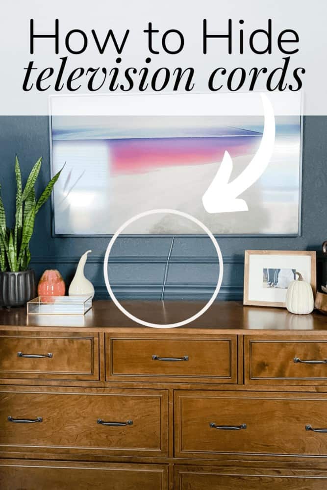 a close up of a television hung above a dresser with a visible cord. There is a text overlay that states "how to hide television cords" 
