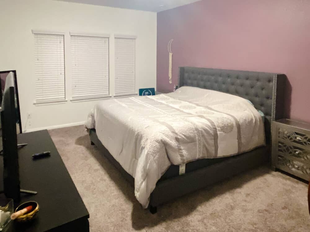 before of master bedroom with purple accent wall 