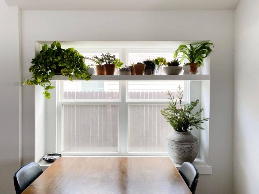 close up of a large window with a shelf installed in the top 