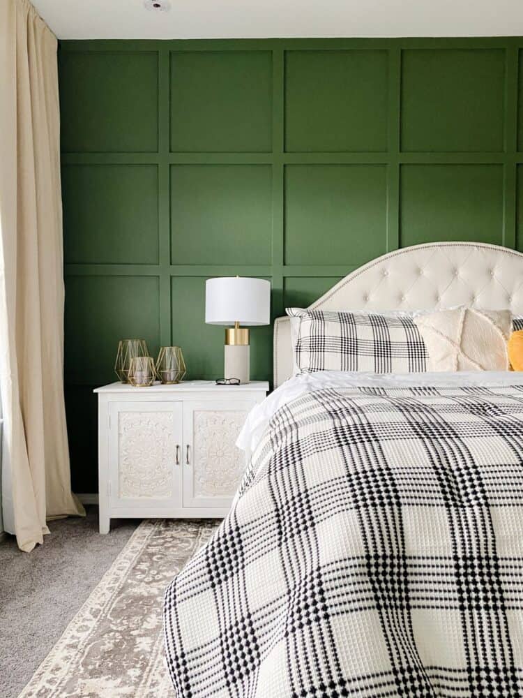 master bedroom with a grid accent wall painted green 