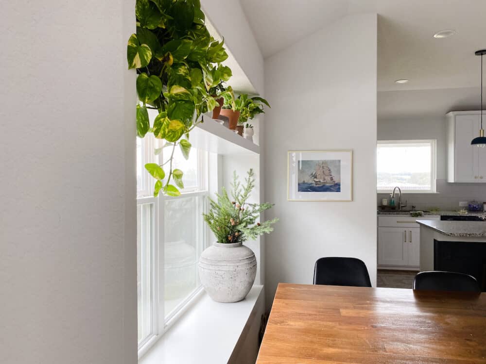 a dining room with art hung on a small wall 