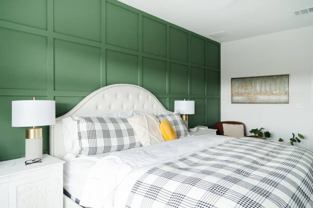 master bedroom with green accent wall and neutral furnishings 