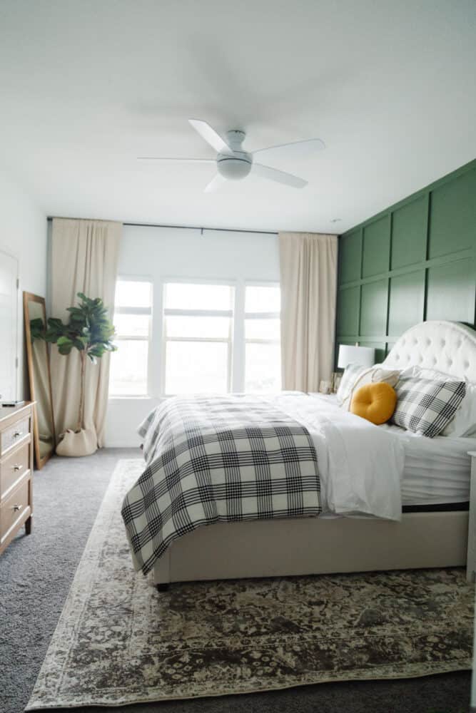 a green and white master bedroom 