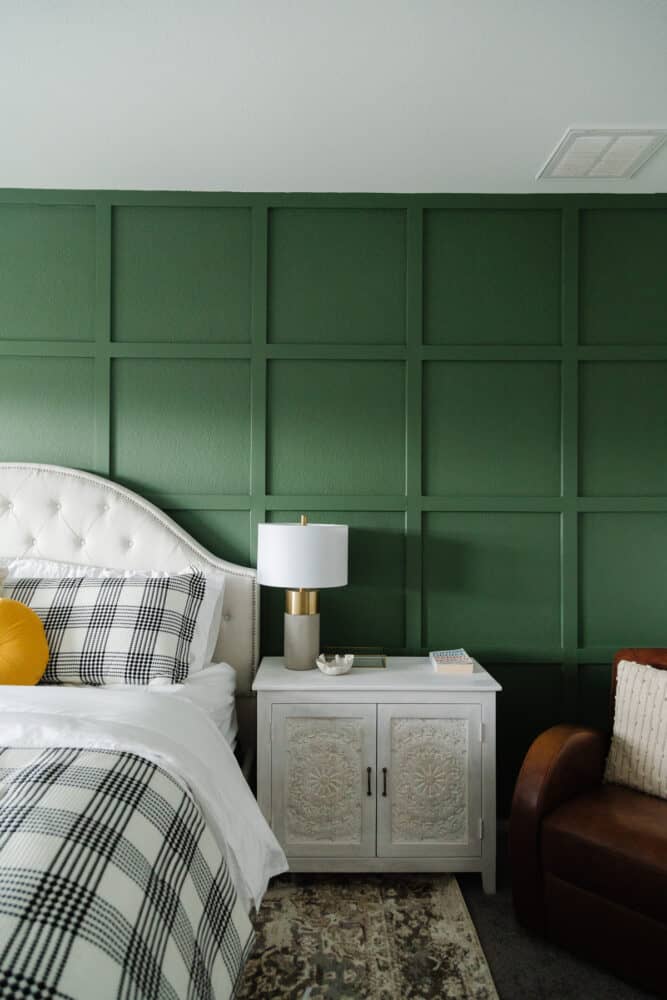 grid accent wall with a white headboard and nightstands 