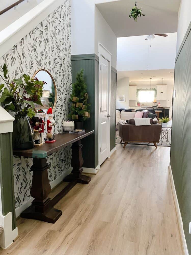 entry with green paneling and floral wallpaper, decorated for Christmas 