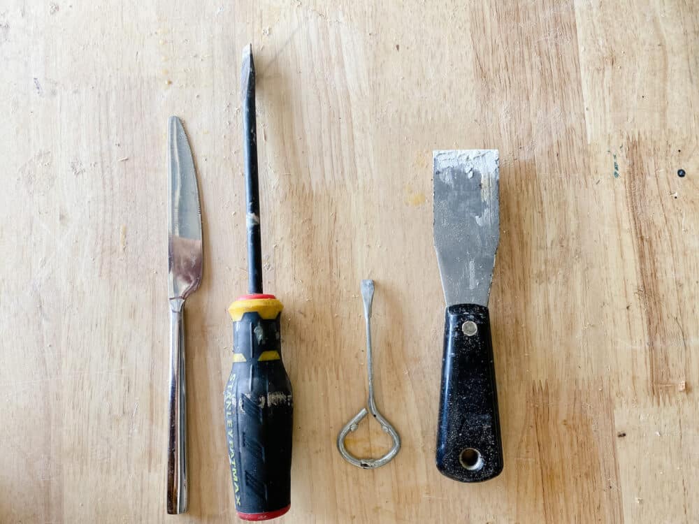 collection of tools that can be used to open a paint can