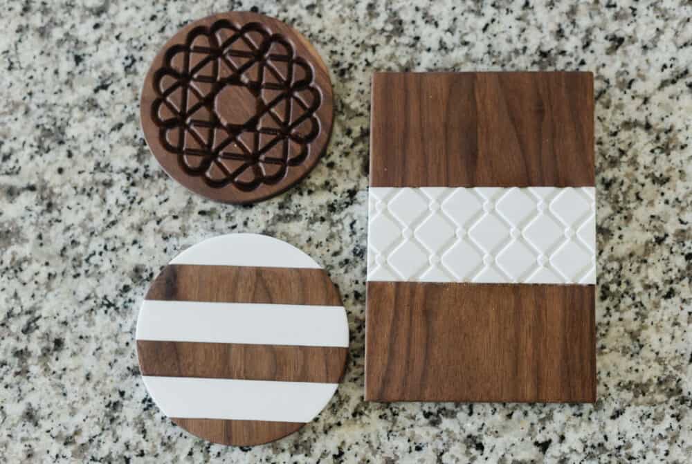 three DIY wood trivets on a granite countertop