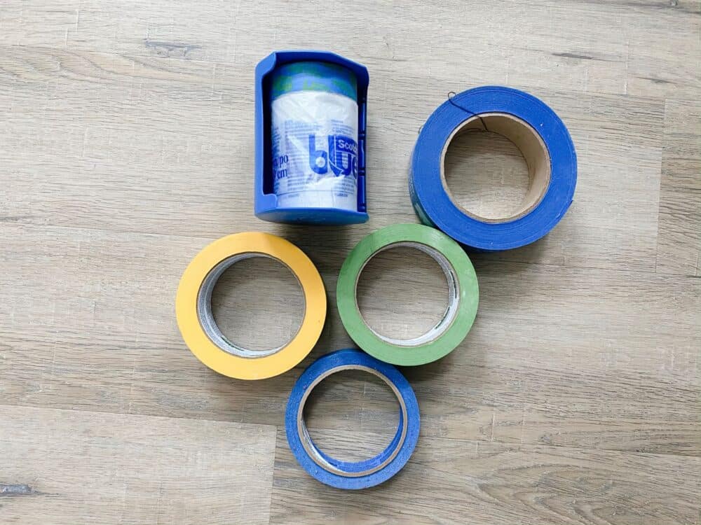 collection of painter's tape laying on wood floor 
