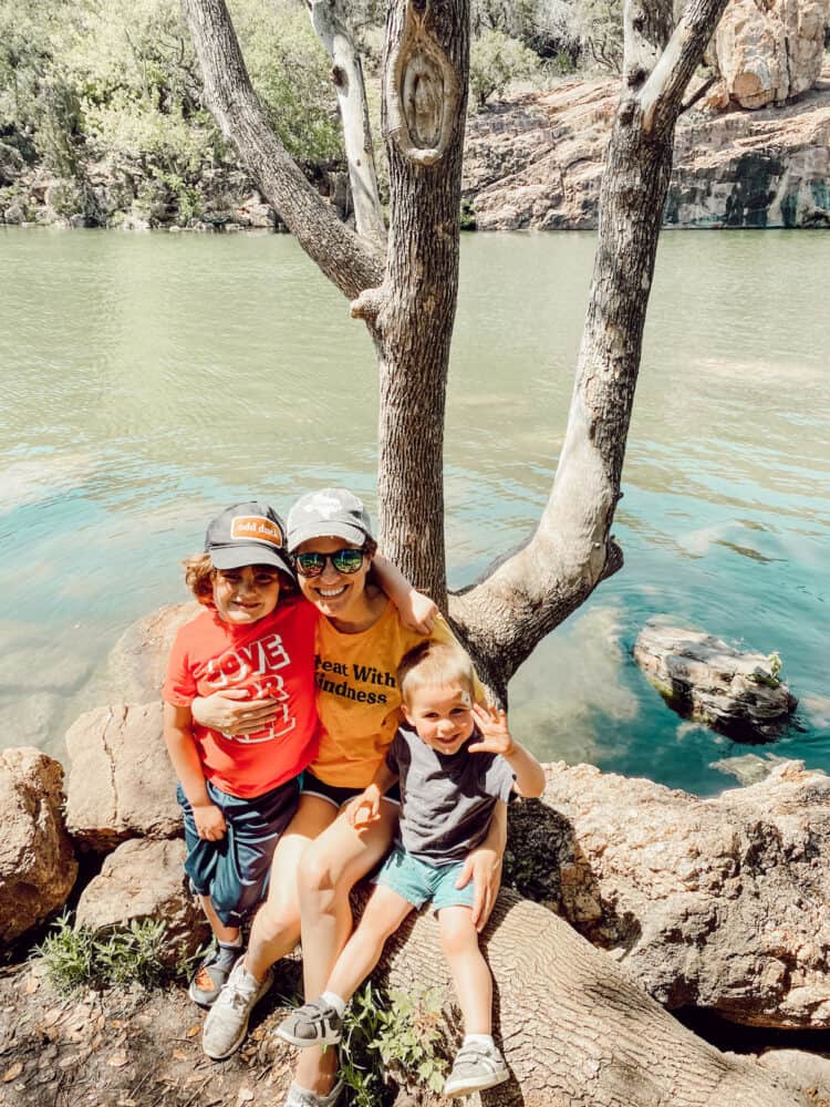 Mom and two young boys near a lake