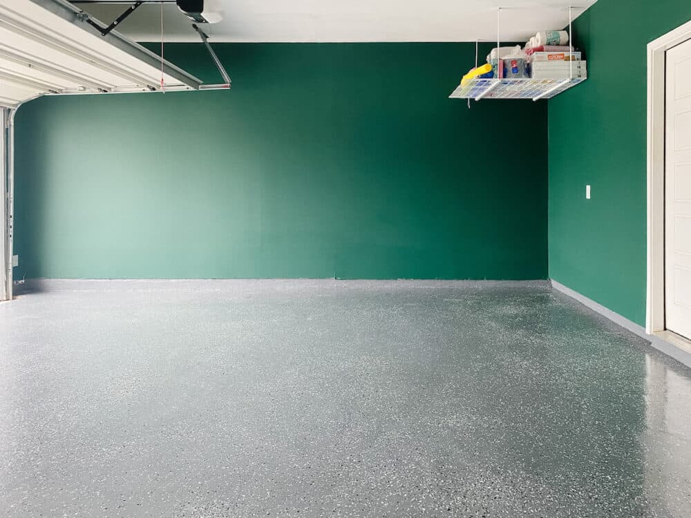 garage with green walls and a gray epoxy flooring